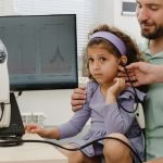 Child,hearing,test.,doctor,audiologist,consulting,father,of,girl,ear