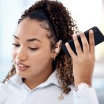 Black,woman,,phone,call,and,loudspeaker,to,listen,in,office
